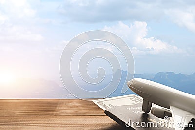 Mountain landscape with a view of the forest and white model of passenger plane on old wooden background. Stock Photo