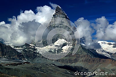 A mountain Matterhorn view partially covered by clouds on a mountain Gornergrat, near Zermatt, in Switzerland Stock Photo