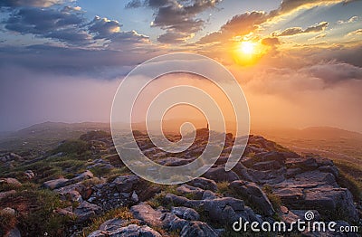 Mountain mist at sunrise with clouds Stock Photo