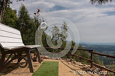 Mountain path with stones and trees and bench Stock Photo