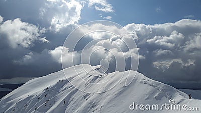Mountain peak against dark clouds with man silhouette Stock Photo