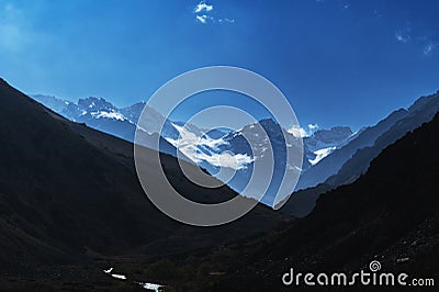 mountain peaks of glaciers with snow on background of a blue Stock Photo