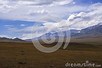 Mountain plateau with ancient mound and cloudy blue sky on background. Rural scenery. Summer nature landscape. Stock Photo