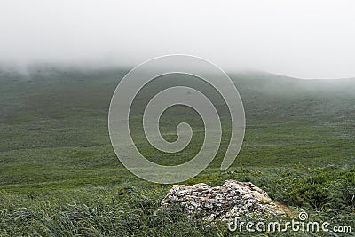 Mountain range in a dense fog in Bieszczady, Poland Stock Photo