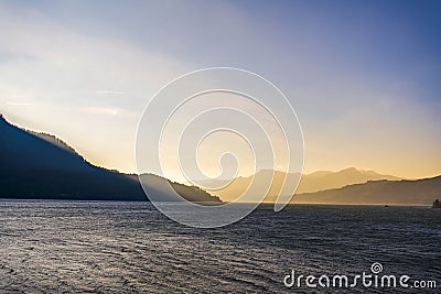 Mountain range illuminated by the oblique rays of the setting sun on the banks of the Columbia River in Colombia Gorge Stock Photo