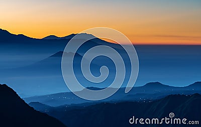 Mountain range landscape and silhouette mountains with colourful fog in sunrise Stock Photo