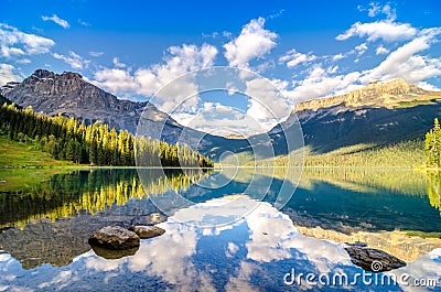 Mountain range and water reflection, Emerald lake, Rocky mountains Stock Photo