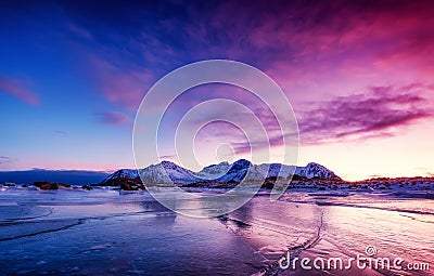 Mountain ridge and ice on the frozen lake surface. Natural landscape on the Lofoten islands, Norway. Stock Photo