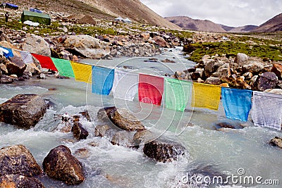 Mountain river and buddhist flags Stock Photo