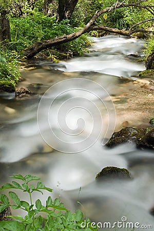 Mountain river falling and flowing trough stone Stock Photo