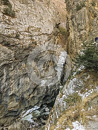 A mountain river flows through a high gorge Stock Photo