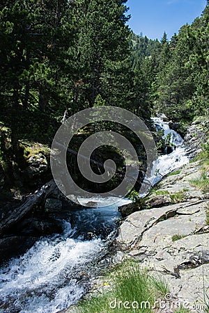 Mountain river landscape in pyrenees, powerful stream of mountain river running down the valley in summer Andorra Stock Photo