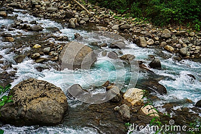 Mountain River rages on rocks on a cloudy day Stock Photo