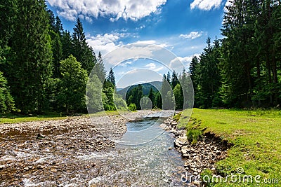 Mountain river runs through countryside valley Stock Photo