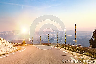 The mountain road descends down the hill. Stock Photo