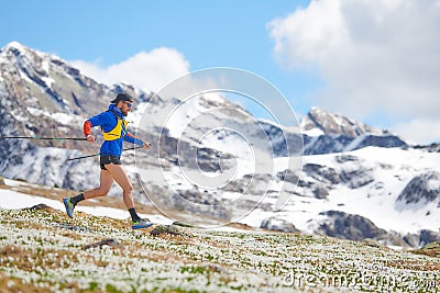 Mountain runner with chopsticks in downhill training Stock Photo