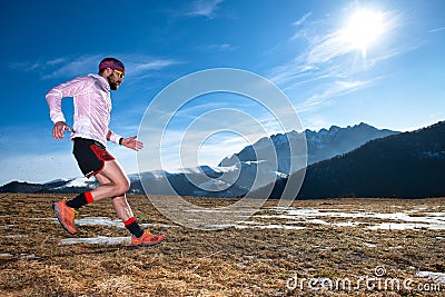 Mountain runner in downhill action on slippery ground Stock Photo