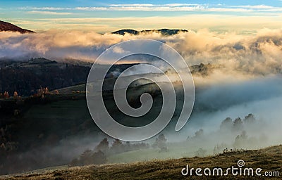 Mountain rural area in foggy autumn morning Stock Photo