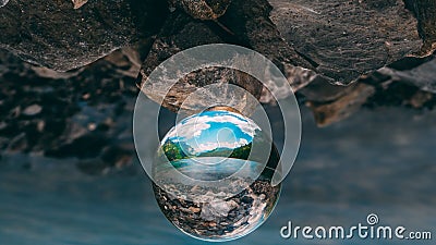 Mountain scenery reflection in a glass ball, lensball. klontalersee in the alps Stock Photo