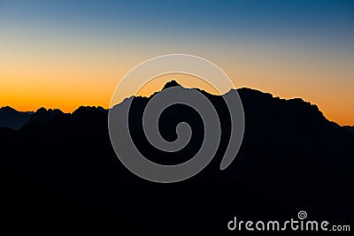 Mountain silhoette of austrian alps at sunrise Stock Photo