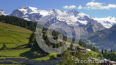 MOUNTAIN WITH SNOW AND GRASS IN VALLE D`AOSTA IN ITALY Stock Photo