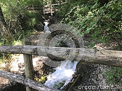 mountain springs of mineral water and cascading waterfalls down the slopes of volcanic rocks, Italian Alps Stock Photo