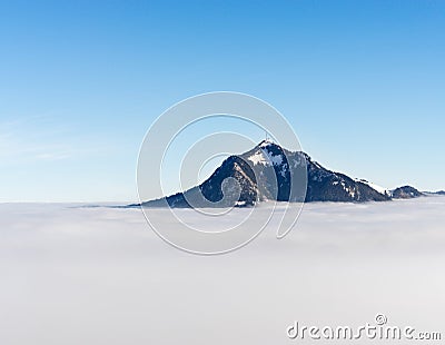 Mountain stick out of foggy cloud layer. Gruenten, Bavaria, Germany. Foresight and vision for business concept and ideas Stock Photo