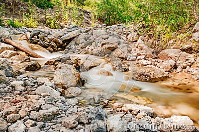 Mountain stream among the rocks in forest, blurred movement of water Stock Photo