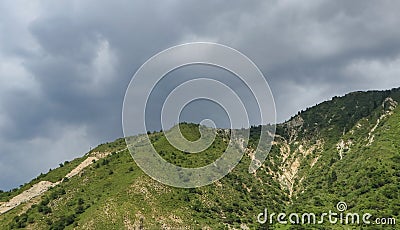 Mountain of the Trans-Ili Alatau with a partially collapsed slope. Stock Photo