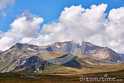 Mountain treeless landscape with clouds and blue sky Stock Photo