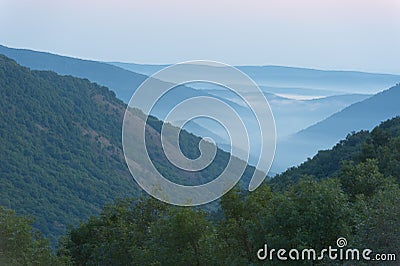 Mountain valley in the fog, horizontal. Stock Photo