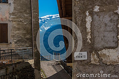 Mountain view form narrow street between old houses. Trento, Italy, Europe. Stock Photo