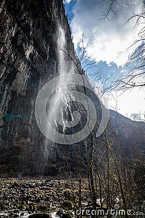 Mountain waterfall in Abkhazia. The wind blows away the pressure of the water Stock Photo