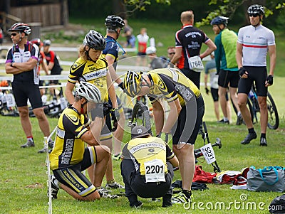 Mountainbike team fixing the bike before the start in the race Editorial Stock Photo