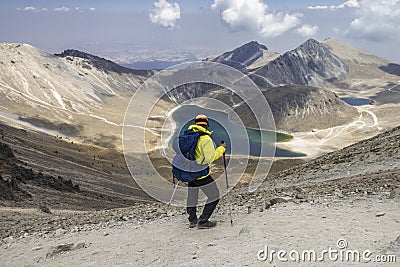 A mountaineer contemplating the volcanic lakes of the crater of the Nevado de Toluca in Mexico Stock Photo