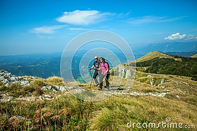 Mountaineer couple on the Nanos plateau in Slovenia overlooking the beautiful Vipava Valley Stock Photo