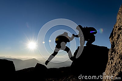 mountaineer help,determination of accomplishment together Stock Photo