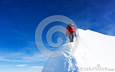 Mountaineer reach the summit of a snowy peak. Concepts: determination, courage, effort, self-realization. Stock Photo