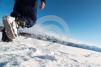 Mountaineer reaches the top of a snowy mountain. Stock Photo