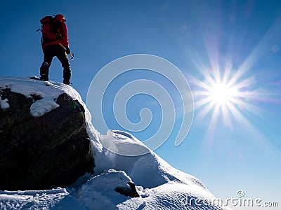 Mountaineer standing at the top of the mountain. Stock Photo