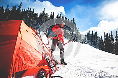 Climber near the tent with snowshoes. Stock Photo