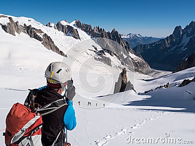 Mountaineer taking picture with a camera in the mountains. Stock Photo