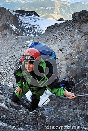 Mountaineer woman climbing Stock Photo