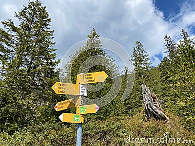 Mountaineering signposts and markings on peaks and slopes of the Pilatus mountain range and in the Emmental Alps, Alpnach Editorial Stock Photo