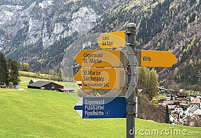 Mountaineering signposts and markings on the slopes of the alpine mountains above the Taminatal river valley and in the massif Editorial Stock Photo