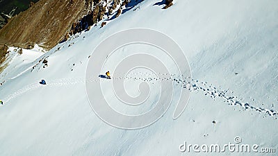 Mountaineers climb the snow up. Among the mountains. Stock Photo