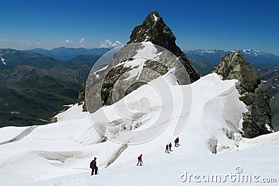 Mountaineers on snow and rocks Stock Photo
