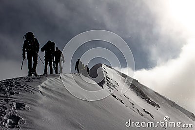 Mountaineers on a snowy mountain ridge on a alpine tour called Spaghetti Round in the European Alps, Monte Rosa Massif, Italy Stock Photo