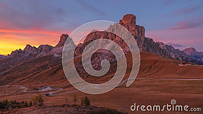 Mountains in the Alps at sunset. View of the alpine valley. Winding road. Mount Passo Giau in the Italian Dolomites Stock Photo