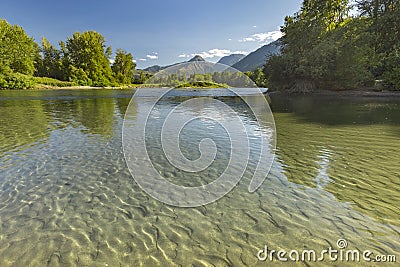 Mountains in the background of the reflective river of Wenatchee in Leavenworth Washington Stock Photo